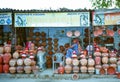 A lady sitting in local market and selling her water pots in indian summer