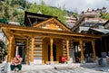 A lady sitting in Sunlight in front of Vashistha temple in Manali, Himachal Pradesh, India.
