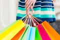 A lady in a skirt is holding a lot of colourful shopping bags. Royalty Free Stock Photo