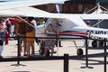 A lady snooping inside a two-seater plane