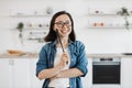 Lady with spatula choosing kitchen tools for cooking at home