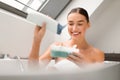 Lady Squeezing Shower Gel On Sponge Taking Bath In Bathroom