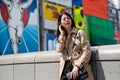 Lady standing in front famous glico running man