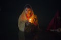 Lady standing in river water at chhat puja