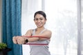 Lady Stretching Resistance Band While Posing In Front Of Camera Royalty Free Stock Photo