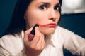 Crazy cheerful woman applying lipstick. Royalty Free Stock Photo