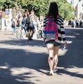 Lady with a tattoo on the calf is in the summer the city centre. Rear view. City life. Saint-Petersburg. The summer of 2017.