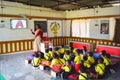A lady teacher taking audio visual class of kindergarten children in a room