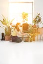 Lady tending to potted plants on summer day