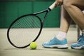 Lady tennis player sitting in the court during game break