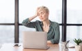 Lady Touching Head Suffering From Pain Sitting In Modern Office