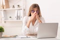 Lady Touching Nosebridge Having Sinusitis Sitting At Laptop At Workplace