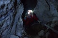 Lady tourist climbs rocks inside the cooperative mine Royalty Free Stock Photo