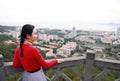 Lady tourist standing on a rock on the top of mountain and admire the view , Xiamen, China Royalty Free Stock Photo