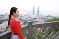 Lady tourist standing on a rock on the top of mountain and admire the view , Xiamen, China Royalty Free Stock Photo