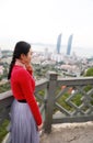 Lady tourist standing on a rock on the top of mountain and admire the view , Xiamen, China Royalty Free Stock Photo