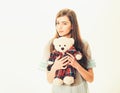 Lady in transparent blue nightie holds teddy bear in hands, white background, copy space. Girl with plush bear toy Royalty Free Stock Photo