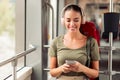 Lady Using Cellphone And Listens Music While Sitting In Tram Royalty Free Stock Photo