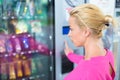 Lady using a modern vending machine Royalty Free Stock Photo