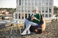 Lady using phone connected to portable power station outside