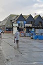 A lady walking in the cold wet weather .