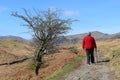 Lady walking on mountain footpath in Lake District Royalty Free Stock Photo