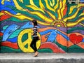 A lady walking past a street wall art