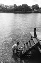 A lady was cleaning dishes at side of jetty, Ko Kret Thailand