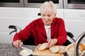 Lady on wheelchair making breakfast Royalty Free Stock Photo