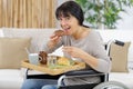 lady on wheelchair making breakfast Royalty Free Stock Photo