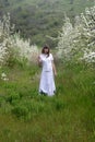 Lady in white between blossoming trees Royalty Free Stock Photo