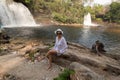 Lady Sitting in Front of the Waterfall known as Gemeas do Itapecuru