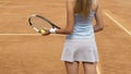 Lady in white sportswear preparing to serve tennis ball, training before match Royalty Free Stock Photo