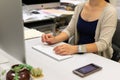 21/11/2020: lady works at home with computer while wearing electronic tracker wristband by Hong Kong Government to monitor those