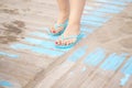 Lady& x27;s feet in sandals on beach Royalty Free Stock Photo