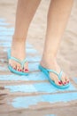 Lady& x27;s feet in sandals on beach Royalty Free Stock Photo