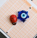 Ladybug,evil eye bead and optical exam paper, exam and luck