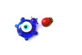 Ladybug and evil eye bead on a white background, close up ladybug, evil eye bead and luck