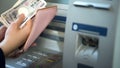 Ladys hands putting Japanese Yen in wallet, cash withdrawn from ATM, travelling