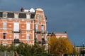 Laeken, Brussels Capital Region, Belgium - Facades of residential houses in a row over dark rainy clouds