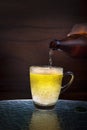 Lager beer drain from bottle to glass on table Royalty Free Stock Photo