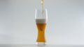 Lager beer filling glass in super slow motion close up. Alcohol drink pouring. Royalty Free Stock Photo