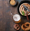 Lager beer with sausage and pretzels Royalty Free Stock Photo