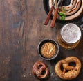 Lager beer with sausage and pretzels Royalty Free Stock Photo