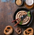 Lager beer with sausage and pretzels Royalty Free Stock Photo