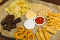 Lager beer and snacks on wooden table. Nuts, chips, peanut, toast, crackers. Appetizer fast food. Craft beer. Beerboard Royalty Free Stock Photo