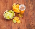 Lager beer and two various potato chips on old table