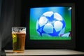 Lager and football on the tv Royalty Free Stock Photo