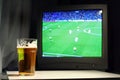 Lager and football on the tv Royalty Free Stock Photo