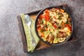 Laghman hand-pulled noodles in tomato and lamb stew closeup on the plate on the wooden board. Horizontal top view Royalty Free Stock Photo